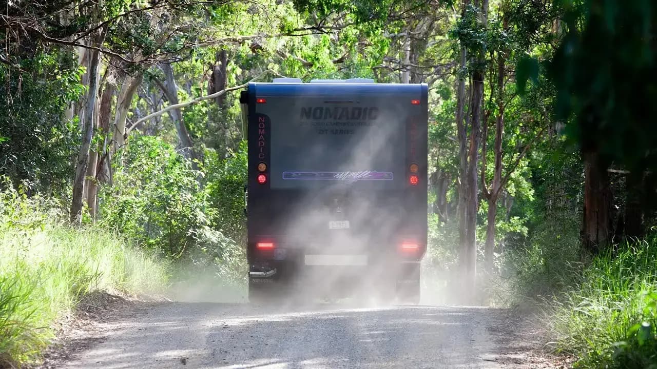 Nomadic off-road caravan being towed along a bush track